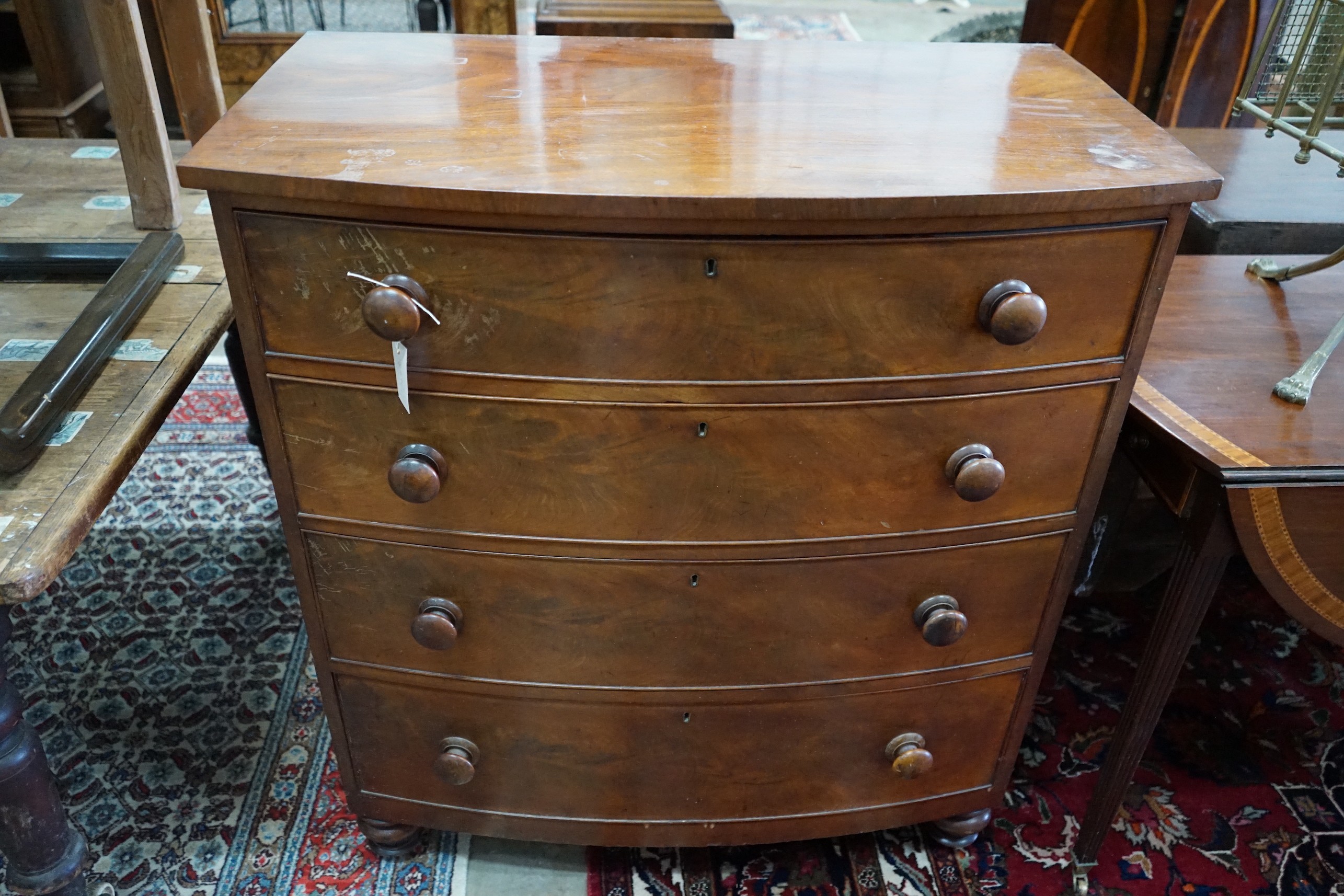 A Regency mahogany bow front chest of four long drawers, width 95cm, depth 54cm, height 106cm